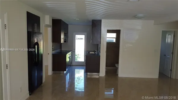 a kitchen with granite countertop a refrigerator and a stove