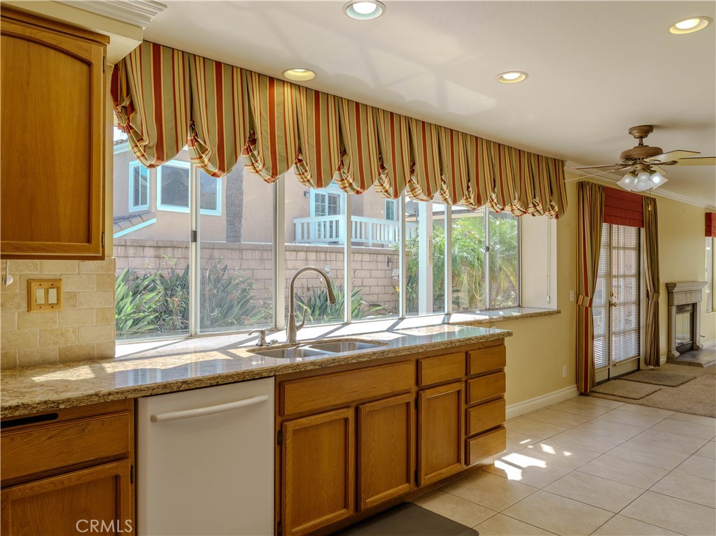 6853 Pandino Court Rancho Cucamonga, CA 91701 - Photo 13 of 44 a kitchen with a sink window and cabinets