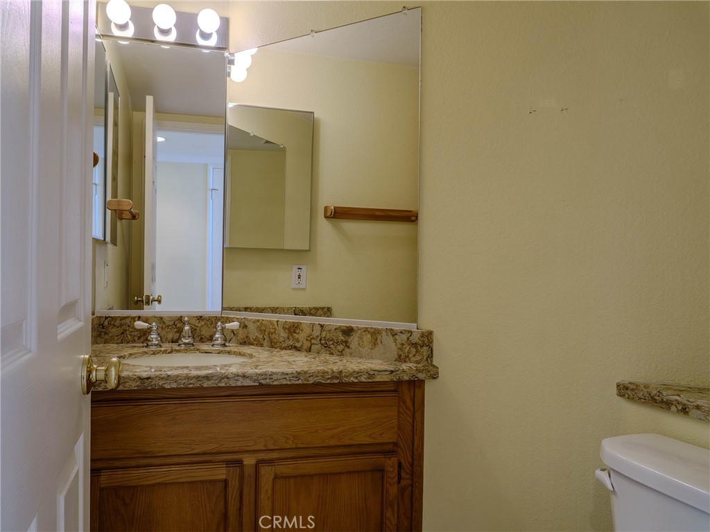 6853 Pandino Court Rancho Cucamonga, CA 91701 - Photo 15 of 44 a bathroom with a granite countertop sink and a mirror