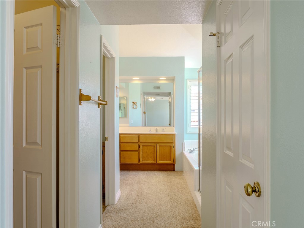 6853 Pandino Court Rancho Cucamonga, CA 91701 - Photo 20 of 44 a bathroom with a granite countertop sink a mirror and a bathtub