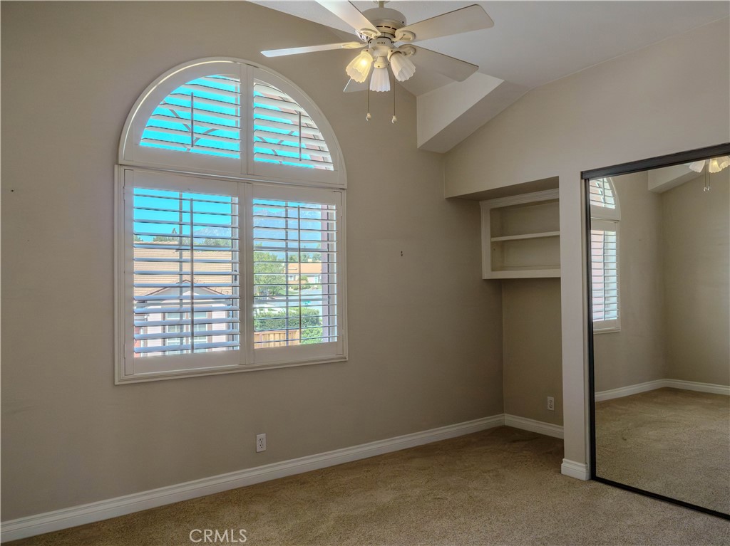 6853 Pandino Court Rancho Cucamonga, CA 91701 - Photo 29 of 44 an empty room with windows and chandelier fan