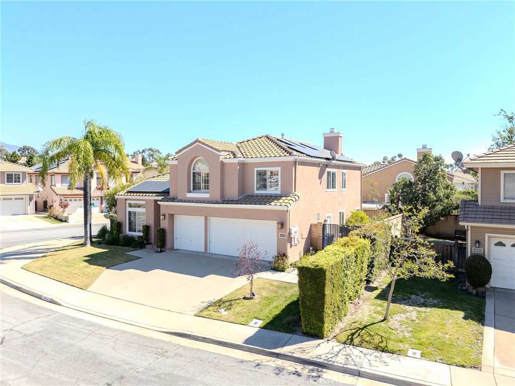 6853 Pandino Court Rancho Cucamonga, CA 91701 - Photo 33 of 44 a front view of a house with a garden