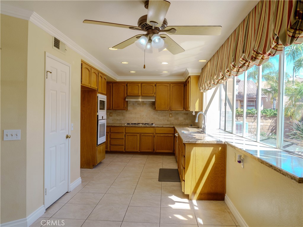 6853 Pandino Court Rancho Cucamonga, CA 91701 - Photo 4 of 44 a kitchen with a refrigerator a sink and dishwasher