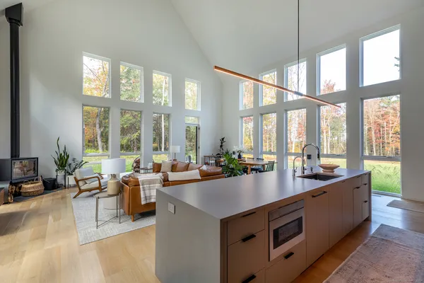 a large living room with a large window and furniture
