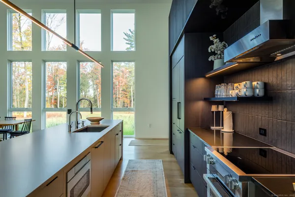 a kitchen with stainless steel appliances granite countertop a sink a stove and cabinets