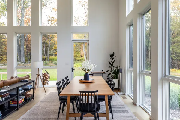 a view of a dining room with furniture and windows