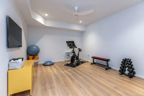 a room with gym equipment and a flat screen tv