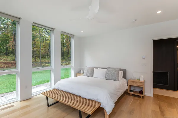 a bedroom with a bed and a large window