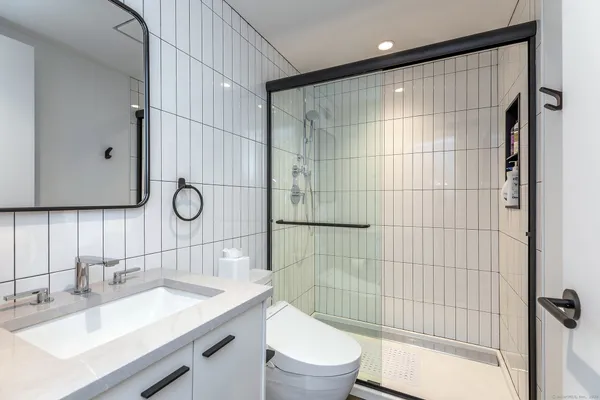 a bathroom with a sink toilet and shower