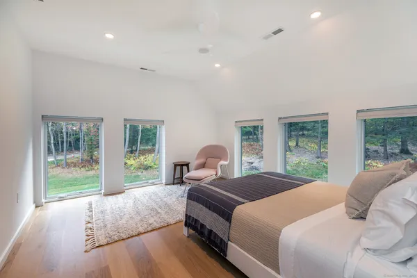 a bedroom with a bed and glass window
