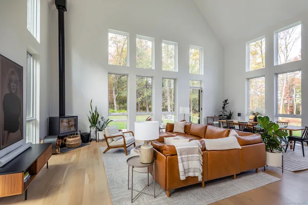 a living room with furniture and large windows