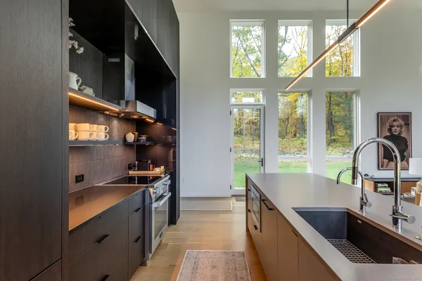 a kitchen with stainless steel appliances granite countertop a sink and a stove