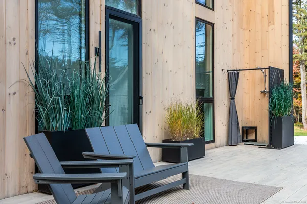 a view of balcony with two chairs and a potted plant