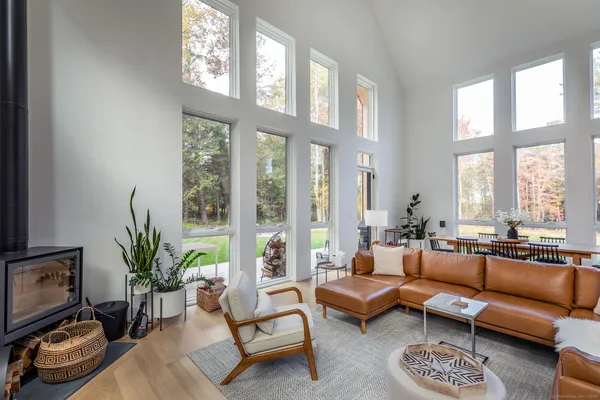 a living room with furniture and floor to ceiling windows