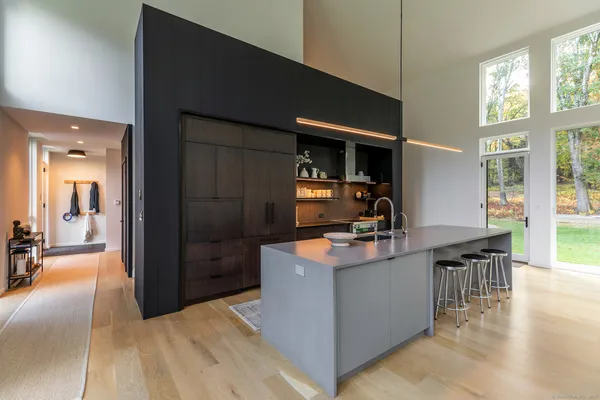 a kitchen with kitchen island a sink stove and a refrigerator