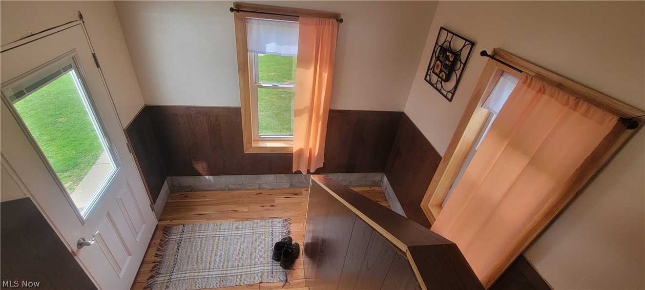 15560 Burton-Windsor Road Middlefield, OH 44062 - Photo 12 of 45 Staircase to basement and to house with wooden walls and plenty of natural light