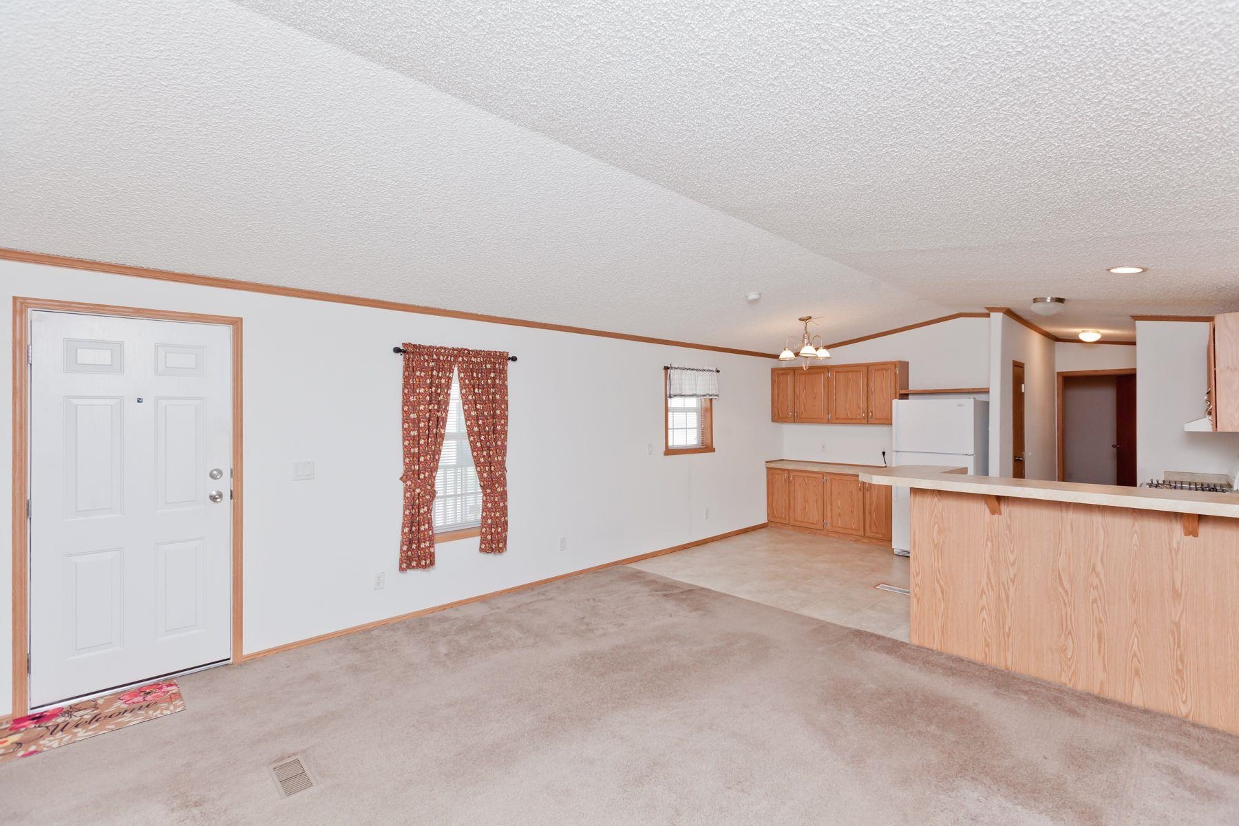 435 32 Road, Unit 232 Clifton, CO 81520 - Photo 11 of 37 an empty room with kitchen view and wooden floor