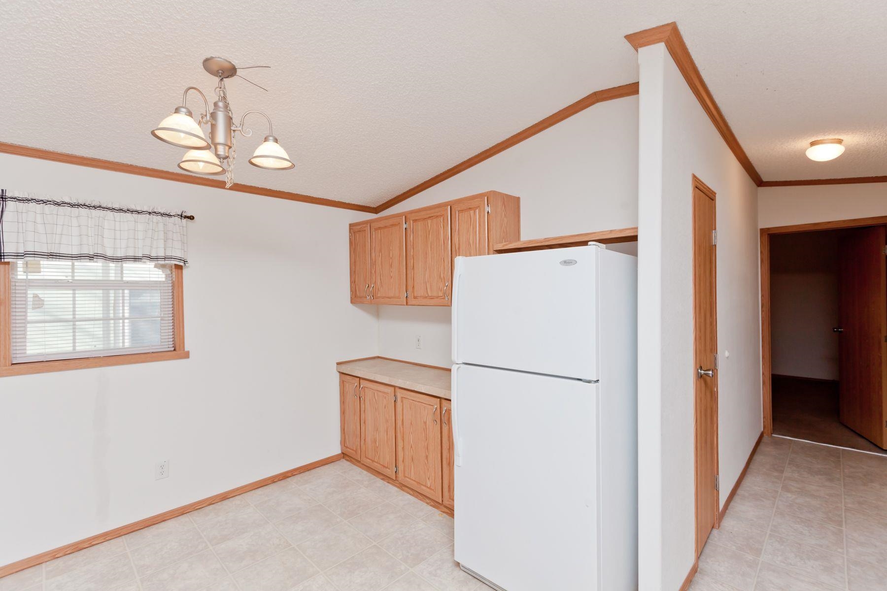 435 32 Road, Unit 232 Clifton, CO 81520 - Photo 18 of 37 a refrigerator freezer sitting in a kitchen with stainless steel appliances wooden cabinets