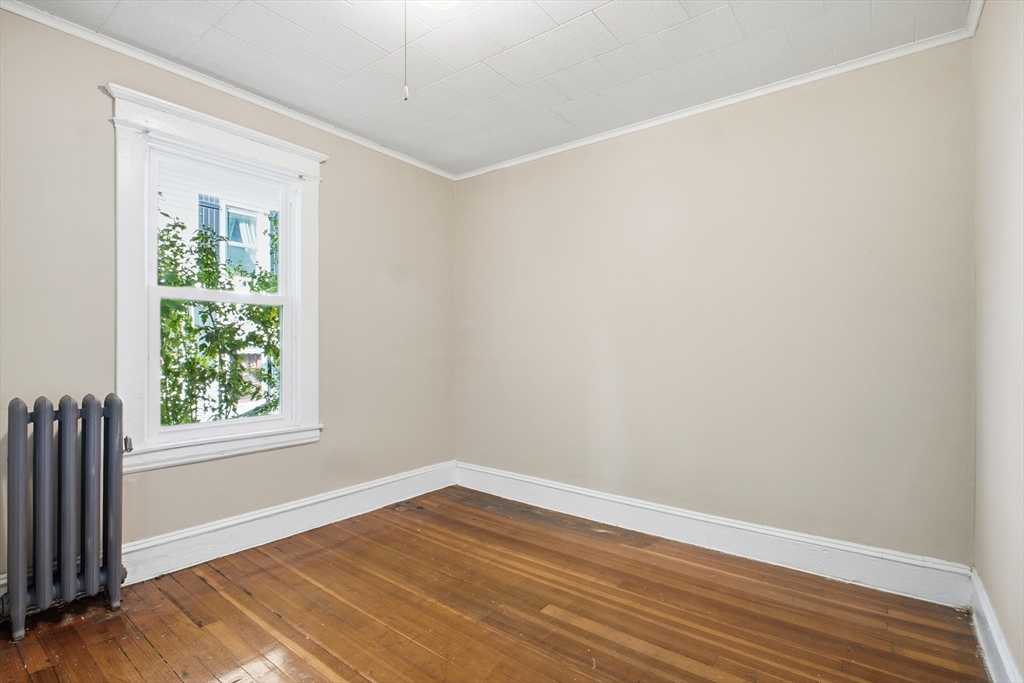 51-53 Abbe Avenue Springfield, MA 01107 - Photo 18 of 42 an empty room with wooden floor and windows
