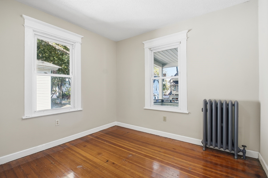 51-53 Abbe Avenue Springfield, MA 01107 - Photo 32 of 42 a view of an empty room with wooden floor and a window