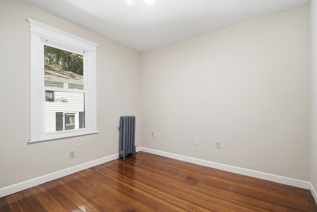 51-53 Abbe Avenue Springfield, MA 01107 - Photo 34 of 42 a view of an empty room with wooden floor and a window