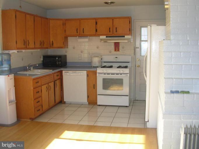 6716 Edsall Road Springfield, VA 22151 - Photo 2 of 17 a kitchen with stainless steel appliances granite countertop a stove a sink and a refrigerator
