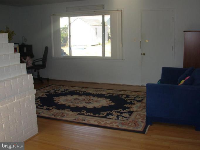6716 Edsall Road Springfield, VA 22151 - Photo 12 of 17 a room with wooden floor and window