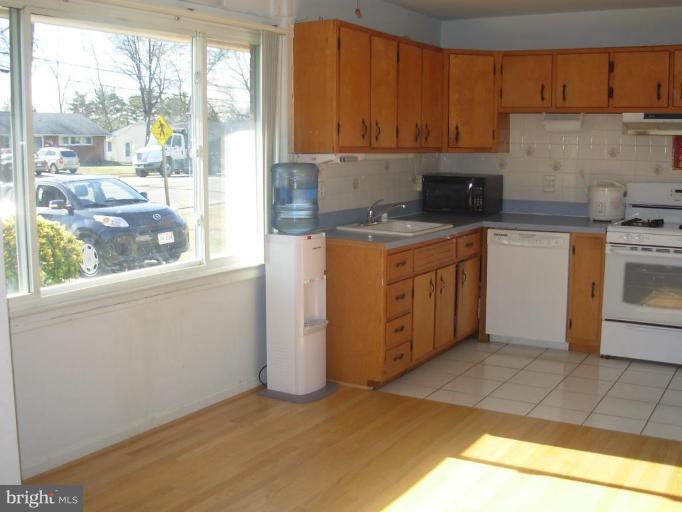 6716 Edsall Road Springfield, VA 22151 - Photo 3 of 17 a kitchen with a sink a stove cabinets and a window