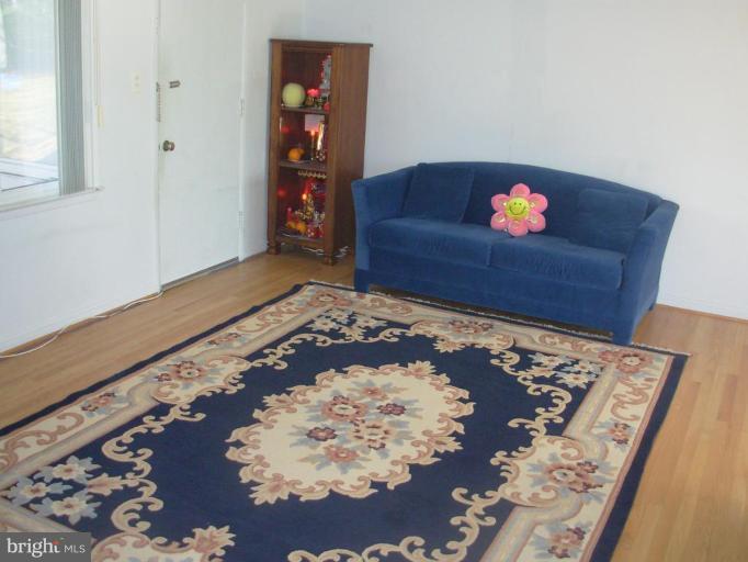6716 Edsall Road Springfield, VA 22151 - Photo 5 of 17 a living room with wooden floor and a rug