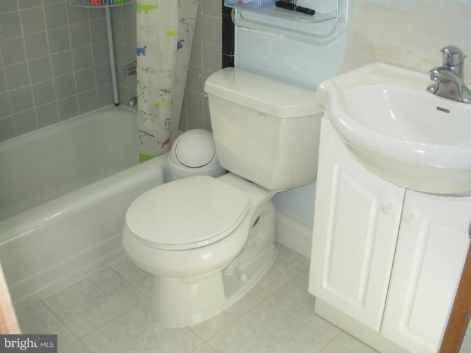 6716 Edsall Road Springfield, VA 22151 - Photo 7 of 17 a white toilet sitting next to a bath tub