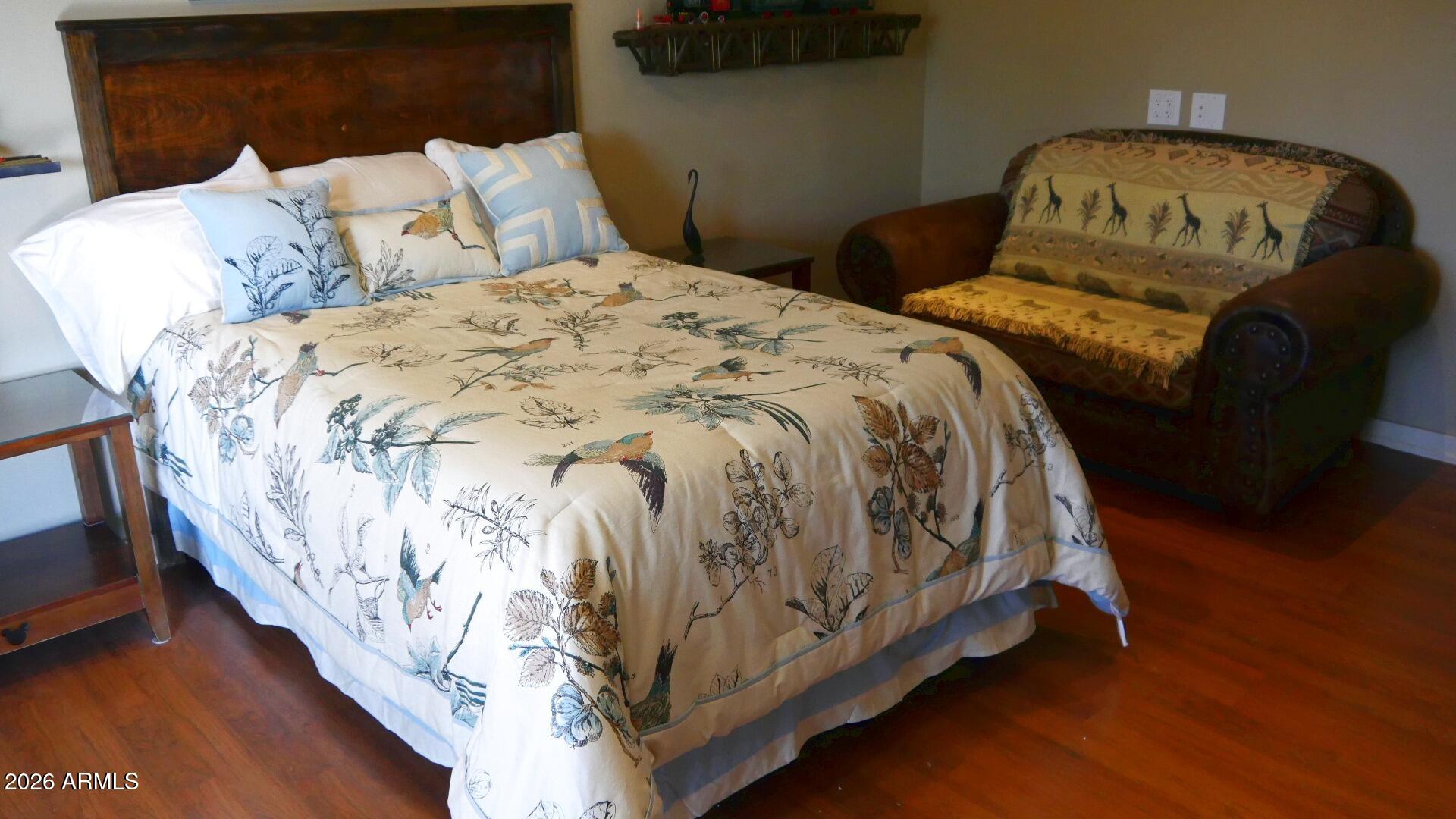 60 Rio Verde Circle Sedona, AZ 86351 - Photo 21 of 28 a bed sitting in a bedroom next to a window with wooden floor