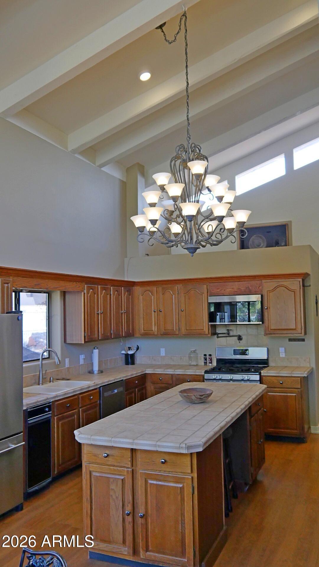 60 Rio Verde Circle Sedona, AZ 86351 - Photo 8 of 28 a kitchen with a stove a kitchen island a sink and a stove