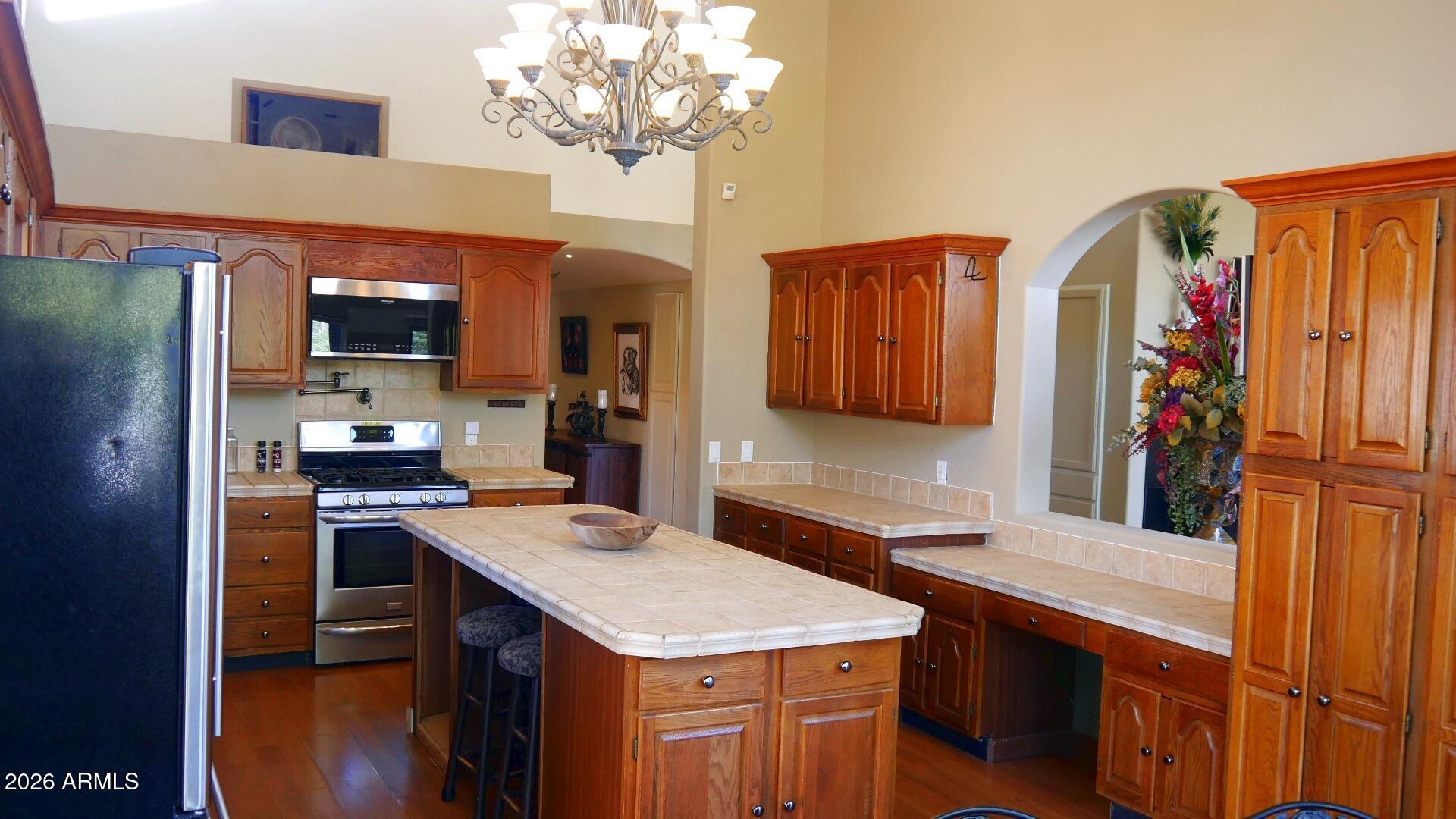 60 Rio Verde Circle Sedona, AZ 86351 - Photo 9 of 28 a kitchen with stainless steel appliances granite countertop a sink refrigerator and cabinets