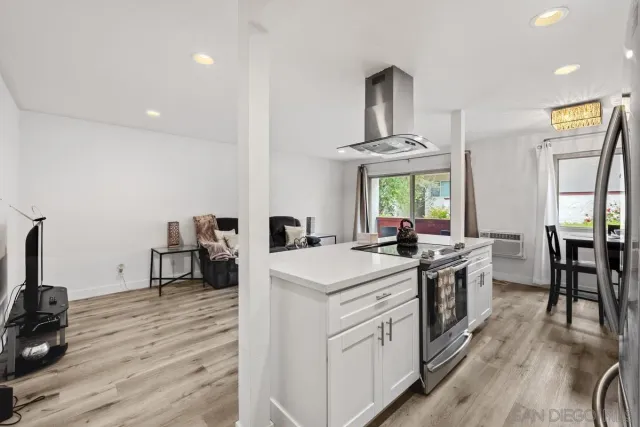 a kitchen that has a stove a table and chairs in it