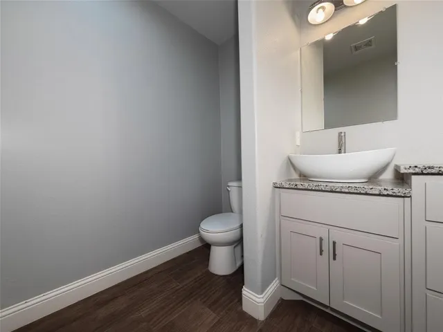 a bathroom with a toilet sink and vanity