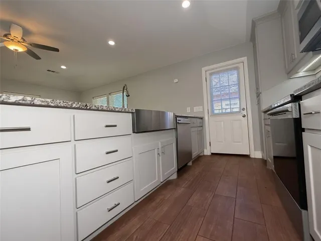 a view of a kitchen with an empty space and a window