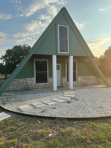 a view of a street with a large tree