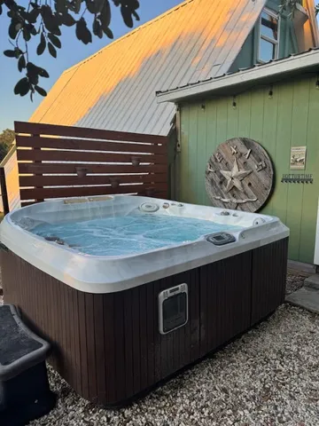 a view of a swimming pool with a wooden fence