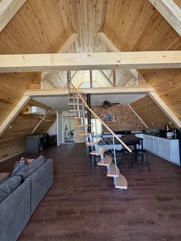 a living room with furniture and a floor to ceiling window