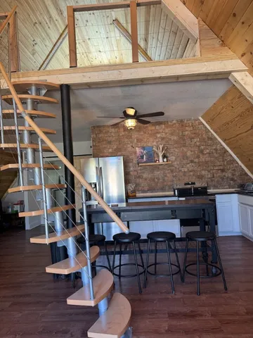 a kitchen with a sink cabinets and wooden floor