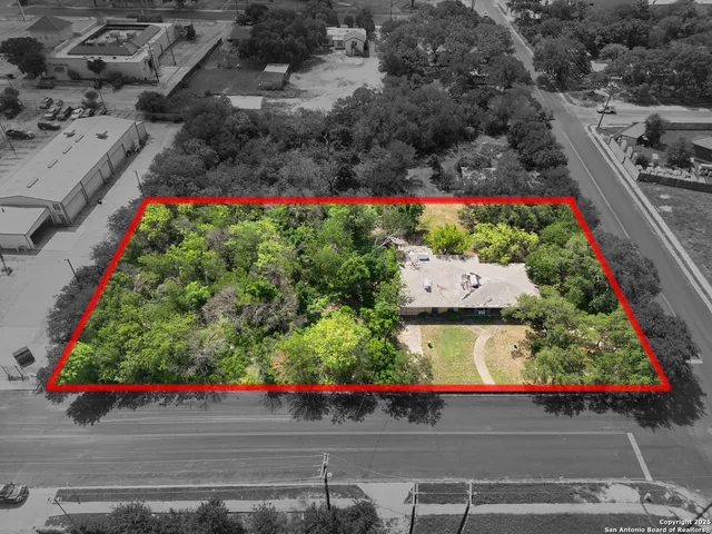 an aerial view of a house with a yard basket ball court and outdoor seating