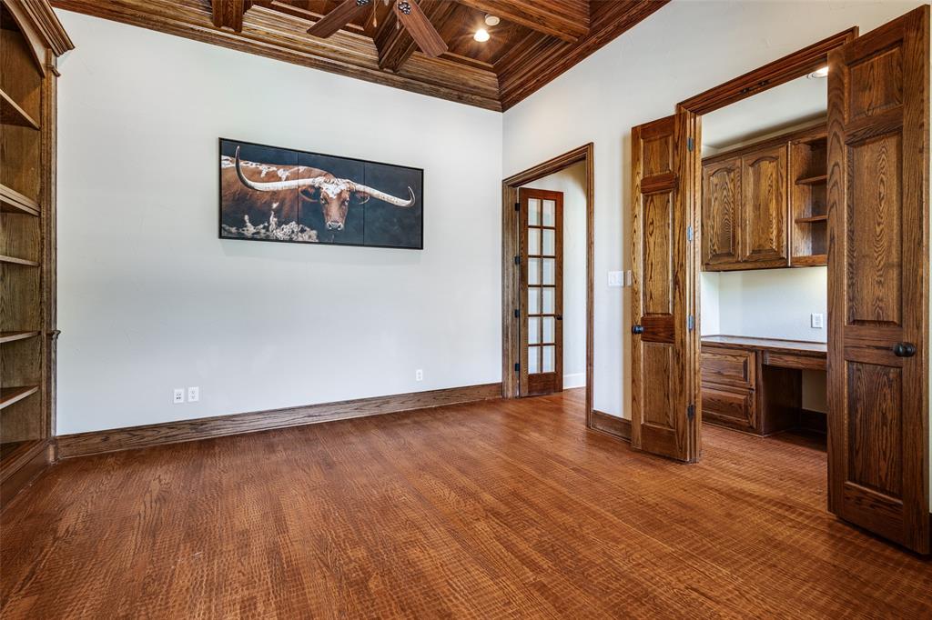 901 Sandy Trail Keller, TX 76248 - Photo 11 of 36 Unfurnished office featuring built in desk, coffered ceiling, crown molding, dark wood finished floors, and wooden ceiling