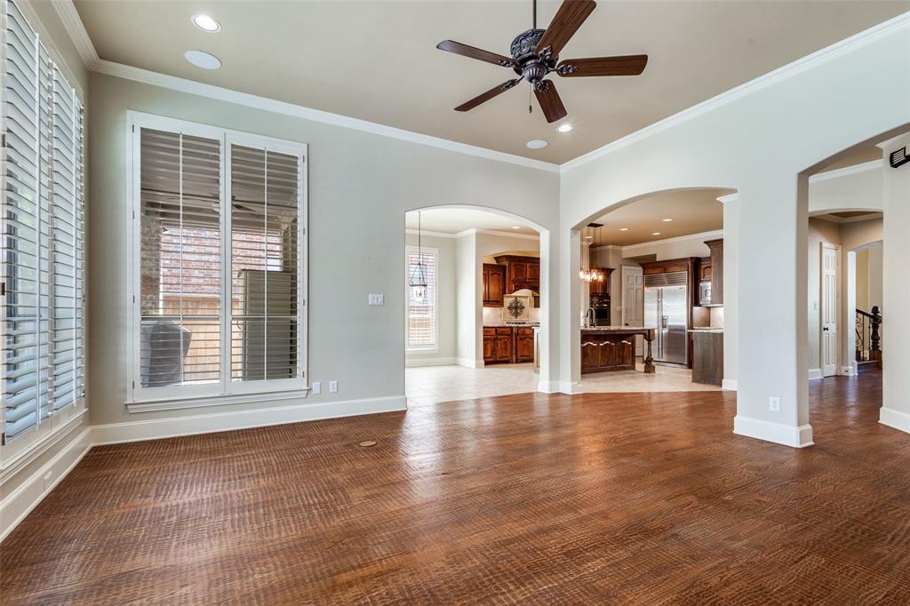901 Sandy Trail Keller, TX 76248 - Photo 14 of 36 Unfurnished living room with ceiling fan, ornamental molding, dark wood-style flooring, recessed lighting, and arched walkways