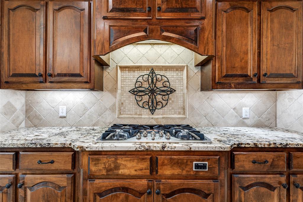 901 Sandy Trail Keller, TX 76248 - Photo 17 of 36 Kitchen featuring light stone counters, stainless steel gas stovetop, and backsplash