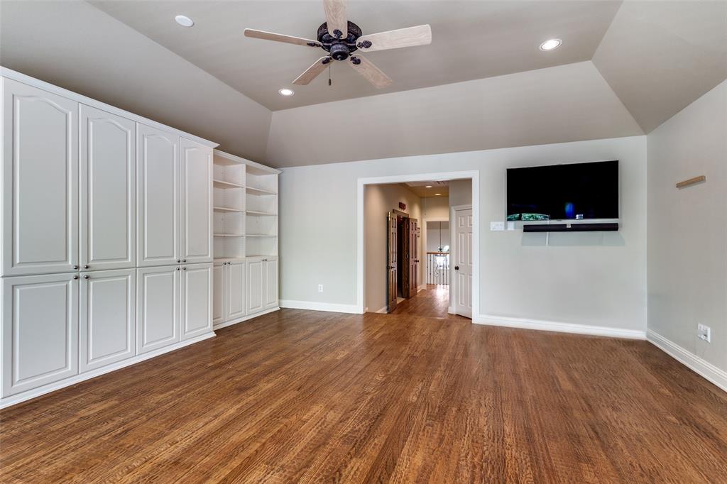 901 Sandy Trail Keller, TX 76248 - Photo 29 of 36 Unfurnished living room with a ceiling fan, dark wood-style flooring, lofted ceiling, and recessed lighting