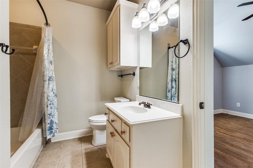 901 Sandy Trail Keller, TX 76248 - Photo 32 of 36 Full bath featuring vanity, shower / bath combo, and light tile patterned flooring