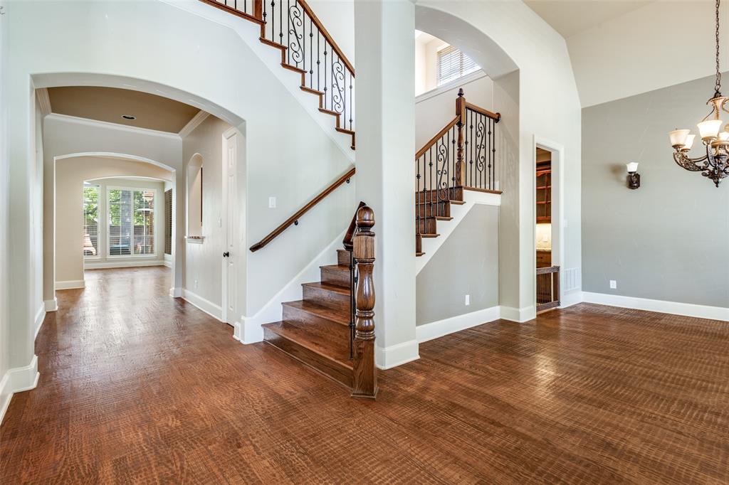 901 Sandy Trail Keller, TX 76248 - Photo 4 of 36 Foyer with arched walkways, a high ceiling, hanging lights, ornamental molding, and dark wood finished floors