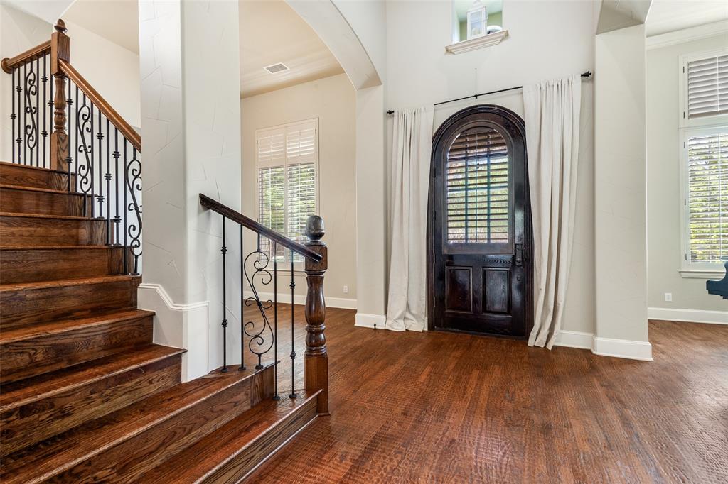 901 Sandy Trail Keller, TX 76248 - Photo 5 of 36 Foyer with arched walkways and dark wood-type flooring