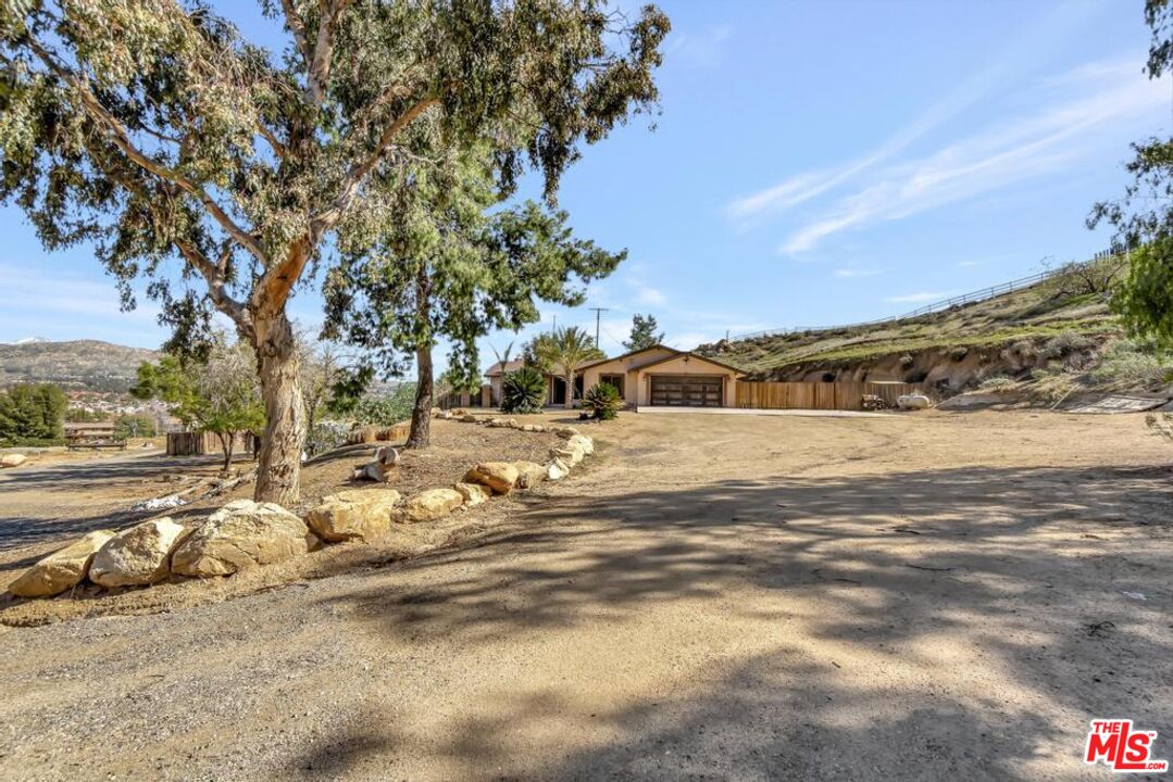 11455 Pigeon Pass Road Moreno Valley, CA 92557 - Photo 13 of 48 a view of road with large trees