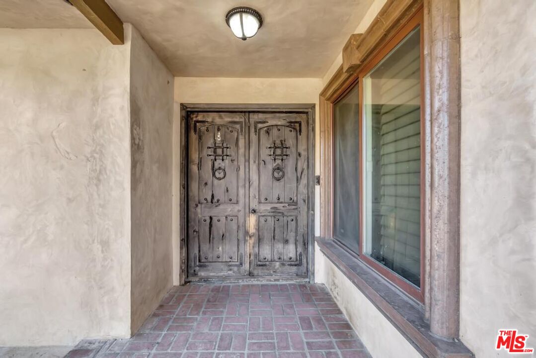 11455 Pigeon Pass Road Moreno Valley, CA 92557 - Photo 14 of 48 a view of a bathroom with a glass door shower and a mirror